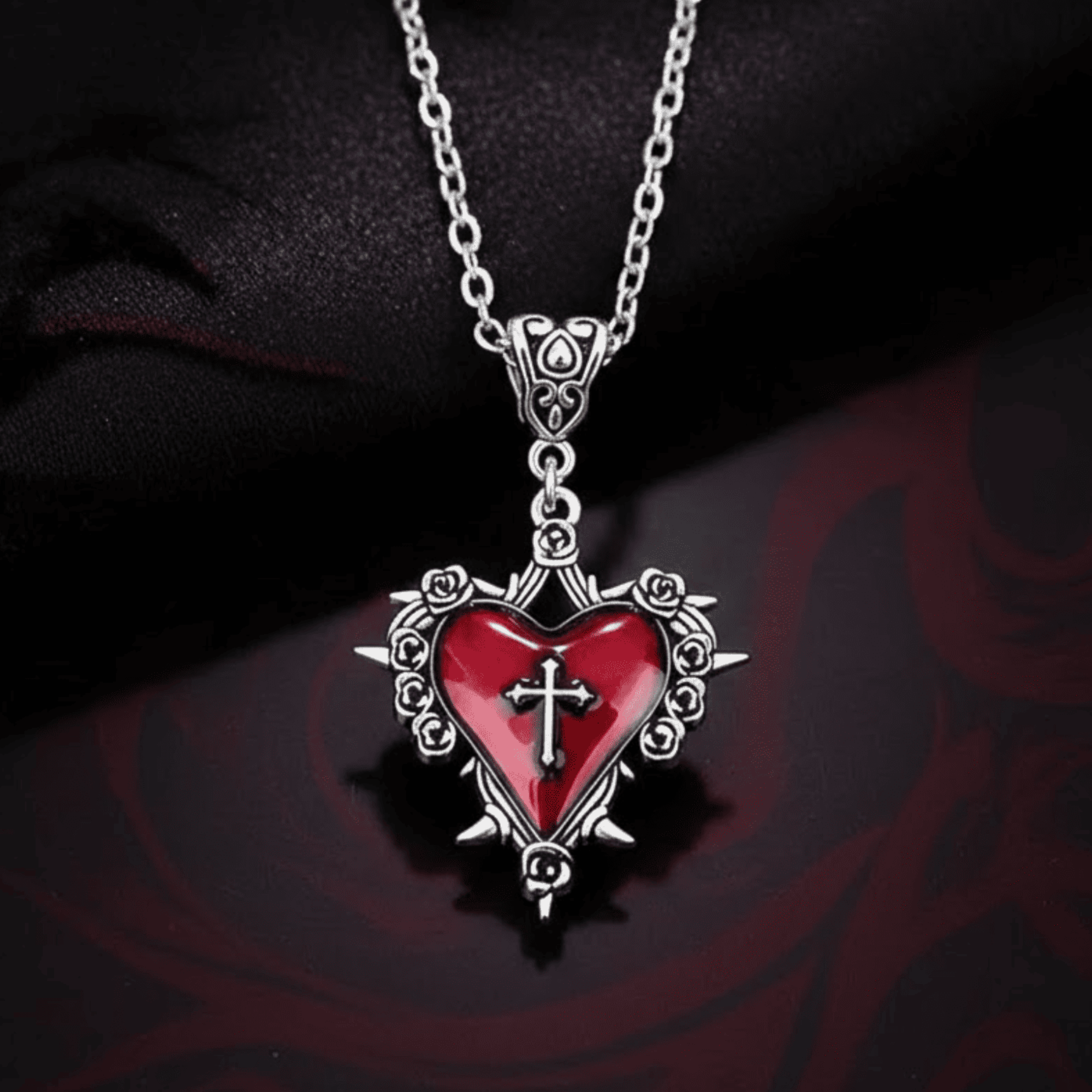 Heart-shaped pendant with a cross on a dark background
